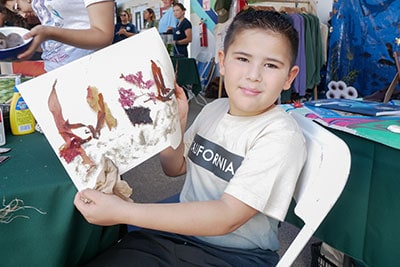 Colorful kelp forest art project with children at Kelp Day educational event.